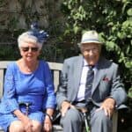 Woman Sitting Beside Man On WOoden Bench