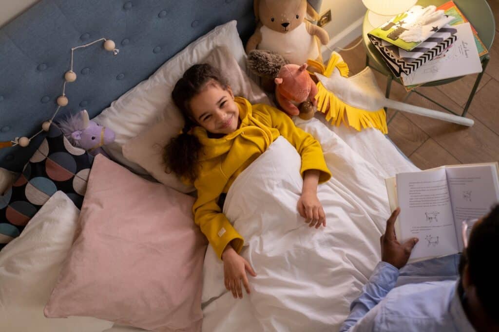 Overhead Shot of a Girl Smiling while Listening to a Bedtime Story