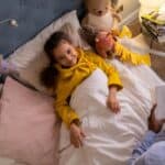 Overhead Shot of a Girl Smiling while Listening to a Bedtime Story